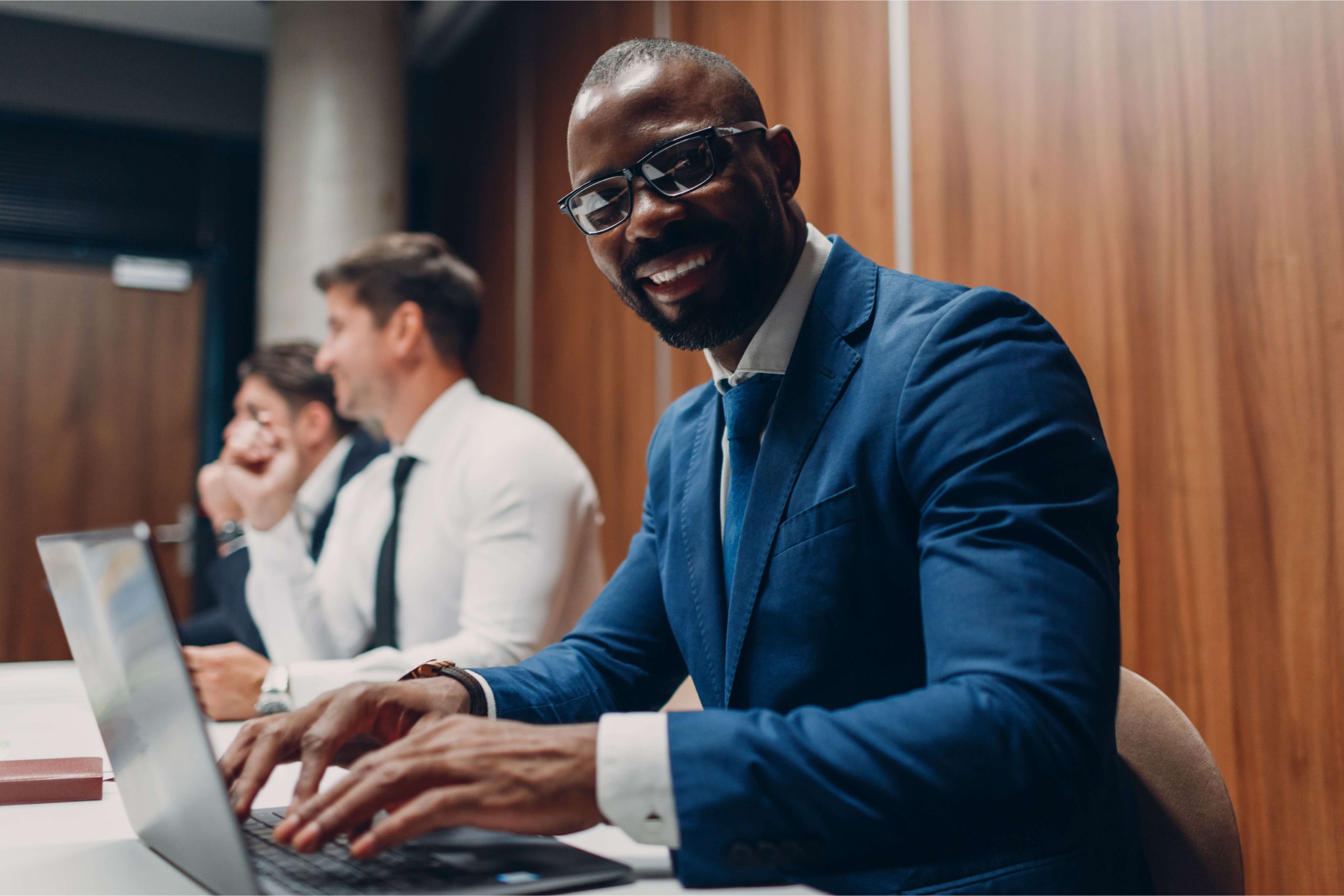 Man Smiling at camera Man doing his business tax in a boardroom